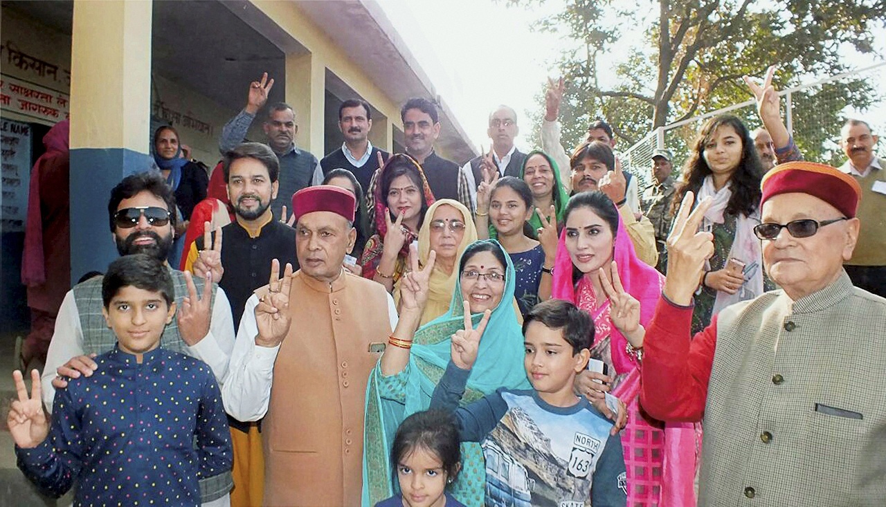  Former Himachal Pradesh CM and BJP candidate Prem Kumar Dhumal, his son and MP Anurag Thakur pose after voting along with other family members in Hamirpur. 

