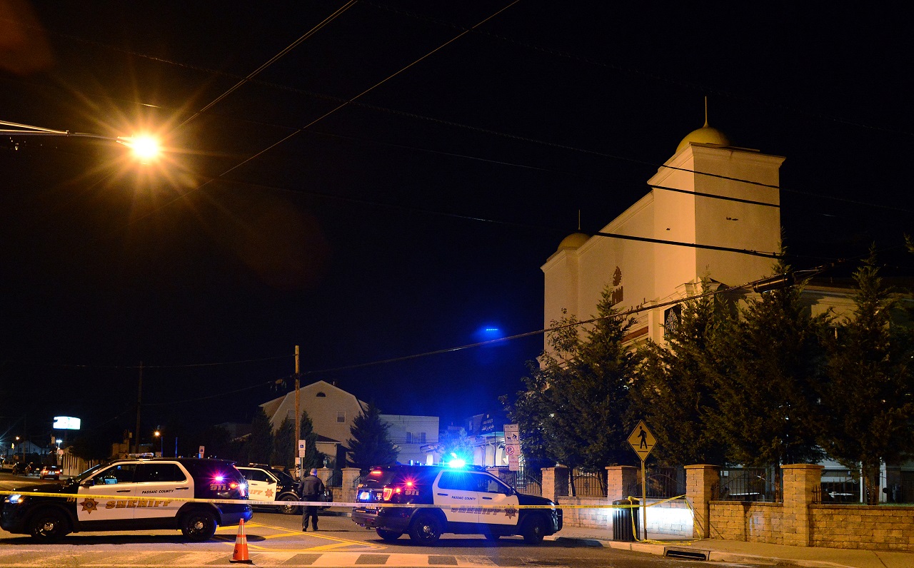   Patterson Police Department vehicles block off a street in front of a mosque  