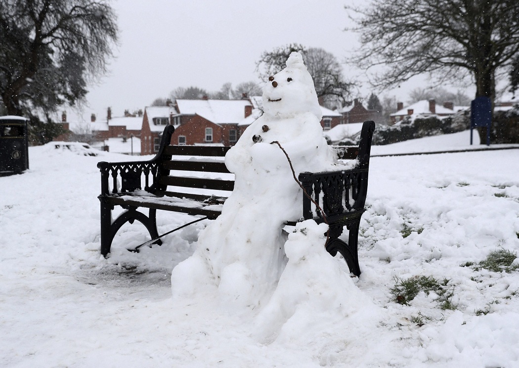   Durham:  A snowman and dog on a bench in Worcester, England on Sunday as heavy snow falls across parts of Britain. Snow is causing travel disruptions across central England and northern Wales, grounding flights, shutting down roads and causing traffic accidents. AP 