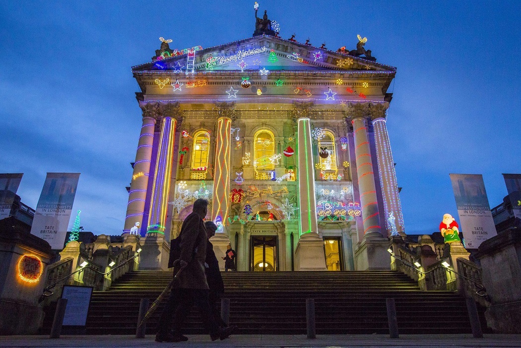   London:  People walk past the Tate Britain gallery in central London decorated with Christmas lights on Thursday. With the holiday season fast approaching buildings across London are being given a festive look. AP 