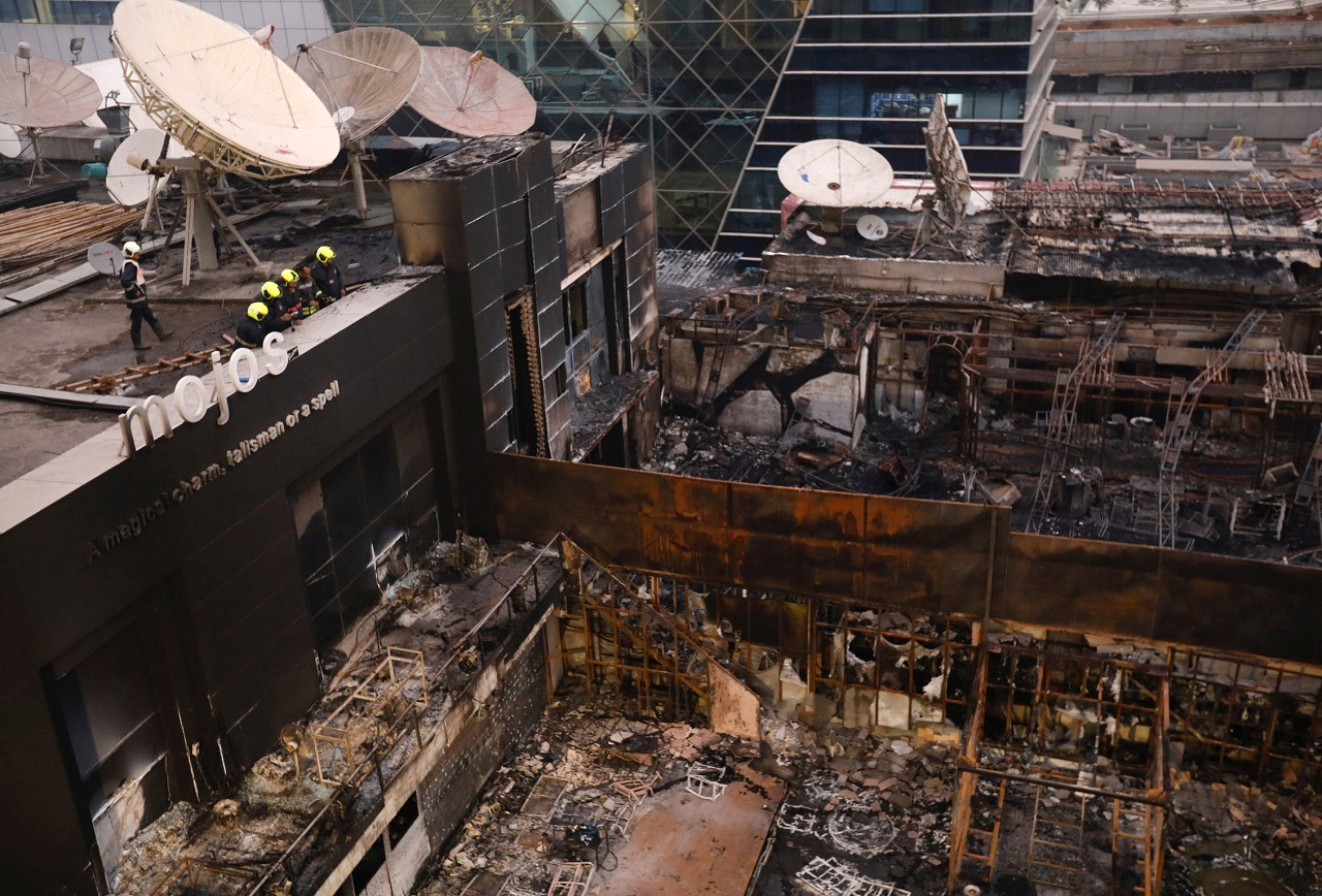    Firefighters inspect the restaurants destroyed in a fire in Mumbai. (Image Courtesy: Reuters)  
