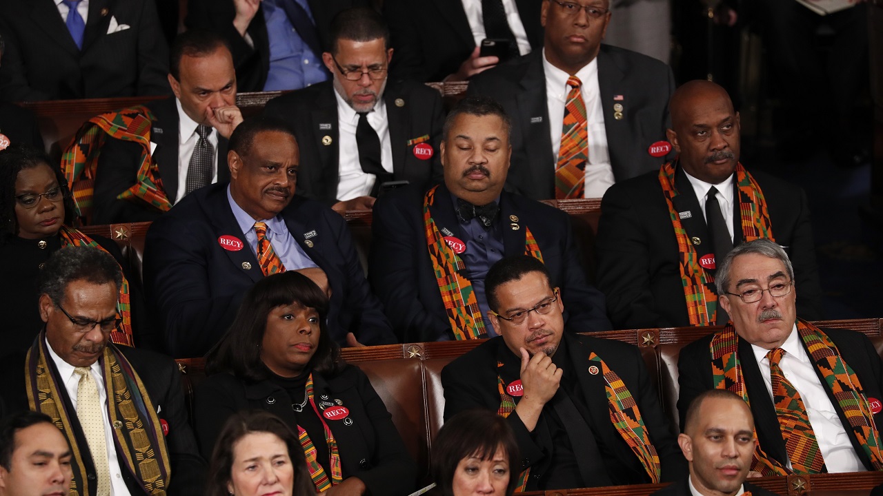  Democratic members of Congress wearing kente cloths in honor of countries allegedly disparaged by USPresident Donald Trump listen to his State of the Union address to a joint session of the USCongress on Capitol Hill in Washington.  (Reuters)  