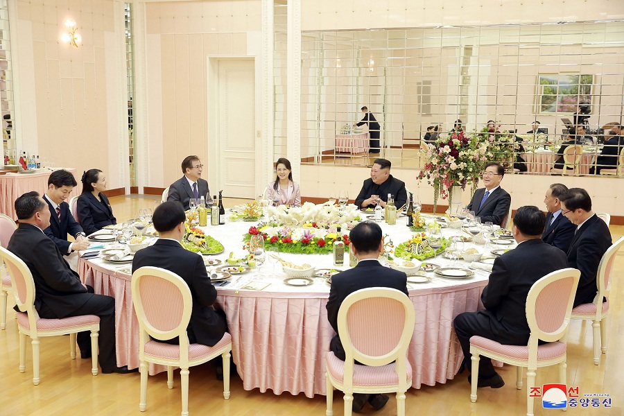    In this March 5 photo, provided by the North Korean government on March 6, North Korean leader Kim Jong Un, centre right in the background, and his wife Ri Sol Ju, centre left in the background, meet members of South Korean delegation headed by National Security Director Chung Eui-yong, right in the background, in Pyongyang. AP   
