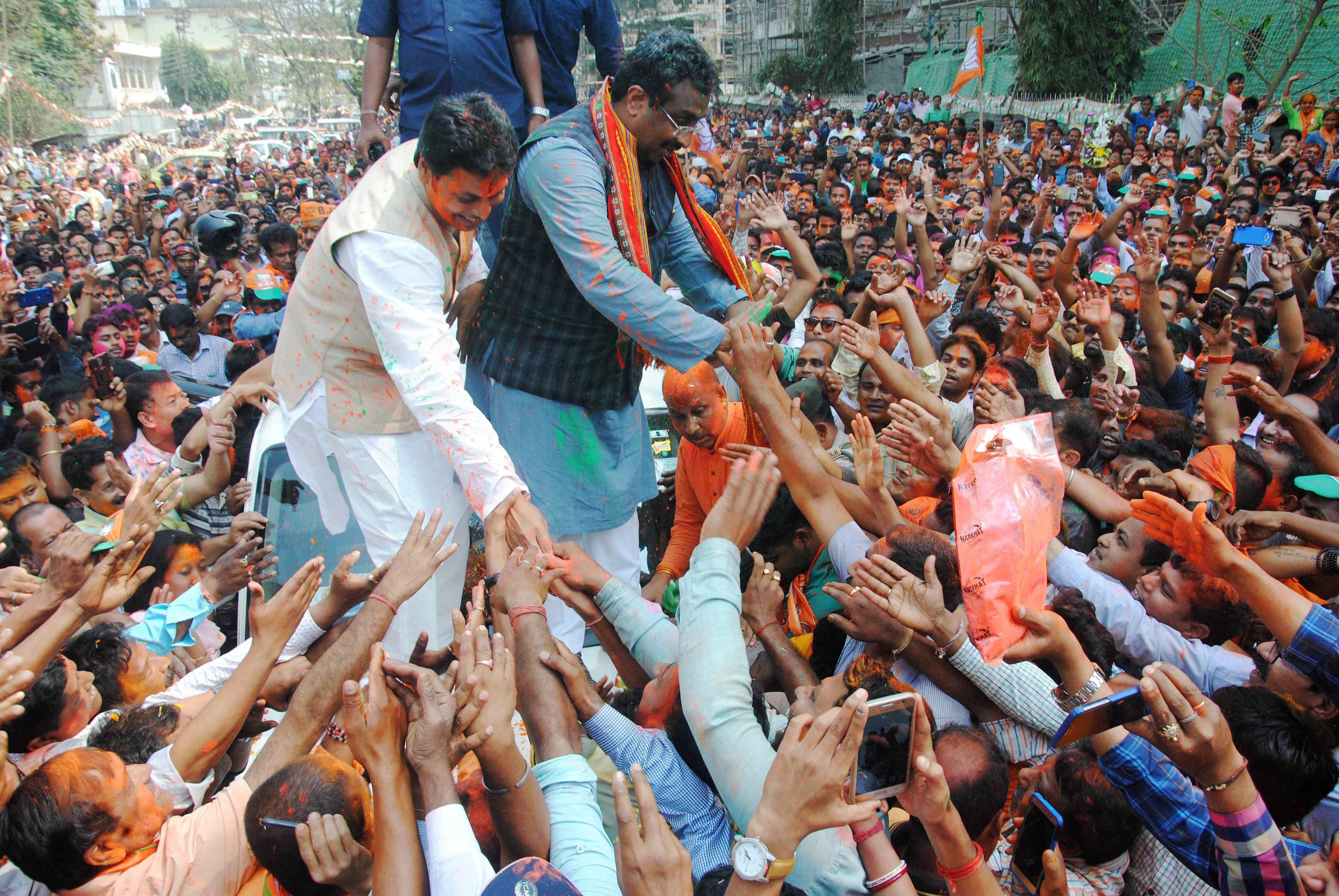  BJP National General Secretary Ram Madhav and Tripura BJP chief Biplab Kumar Deb greet the supporters in Agartala. PTI  