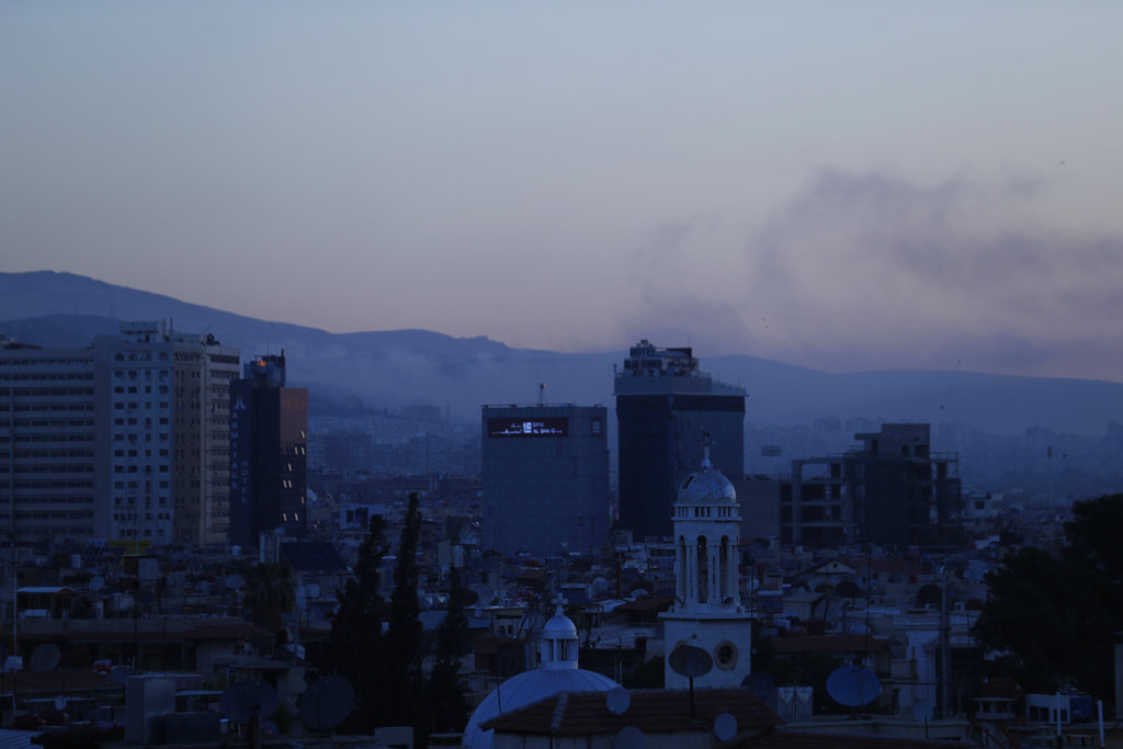  Smoke rises after airstrikes targeting different parts of the Syrian capital Damascus. Image: AP 