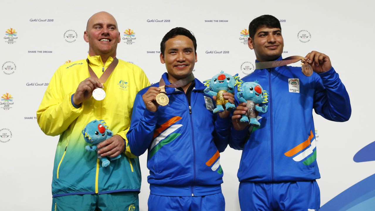    Men's 10 metres pistol | Gold medallist Jitu Rai of India ,silver medallist Kerry Bell and bronze medallist Om Mitharval of India pose with their medals and Borobi plush dolls. (Image: Reuters)   