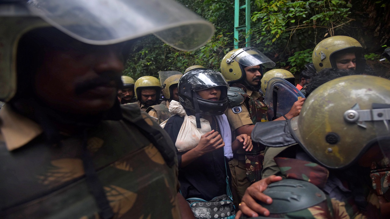  Police officers escort activist Rehana Fathima, who made an attempt to enter Sabarimala temple earlier in the daywith journalist Kavitha Jakkal. The duowas forced to return after the priest of the temple refused to open the temple for them. (Image: Reuters) 