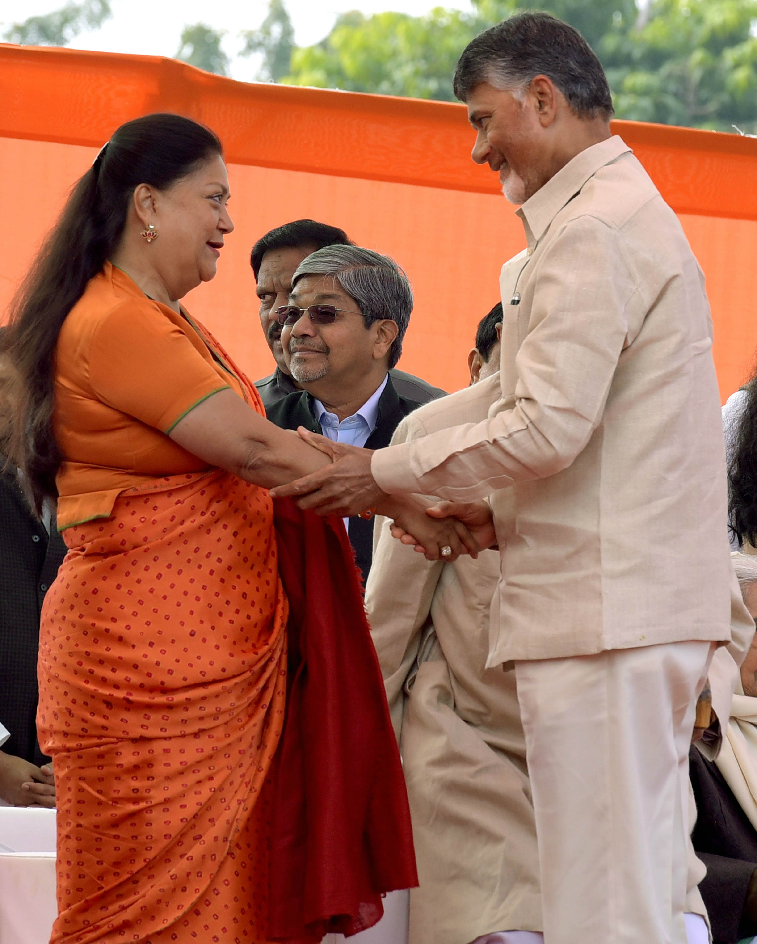    Former Rajasthan chief minister Vasundhara Raje greets Andhra Pradesh Chief Minister N Chandrababu Naidu during Ashok Gehlot’s swearing-in ceremony at Albert Hall in Jaipur. (Image: PTI)  