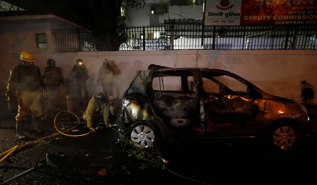  Firefighters douse a car after demonstrators set it on fire during a protest against the citizenship law in Delhi. (Image: Reuters) 